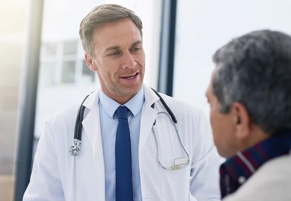 Doctor talking with an older patient during a consultation